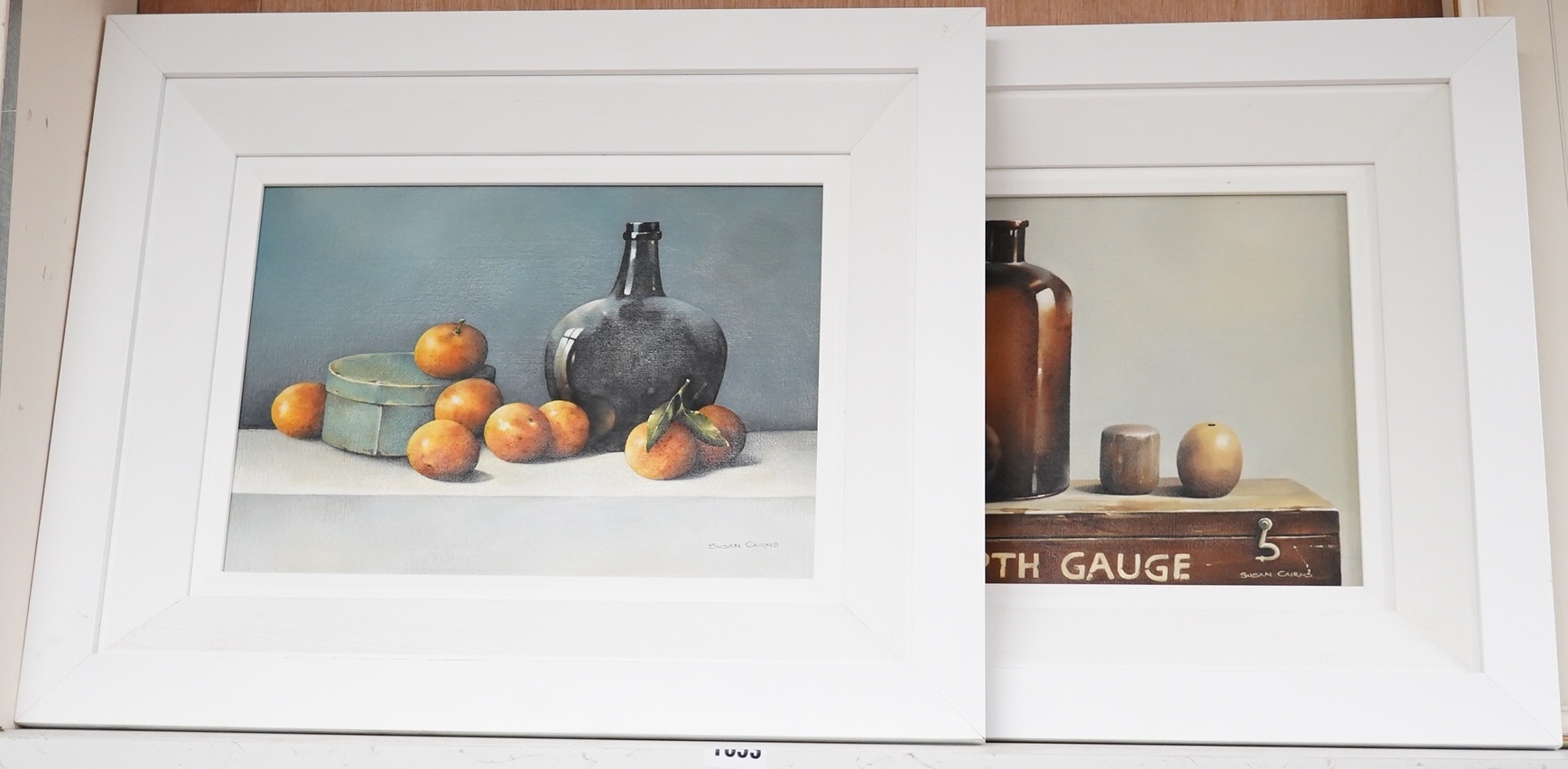 Susan Cairns (Irish), pair of oils on board, Still lifes of fruit and vessels, each signed, 24 x 35cm. Condition - good